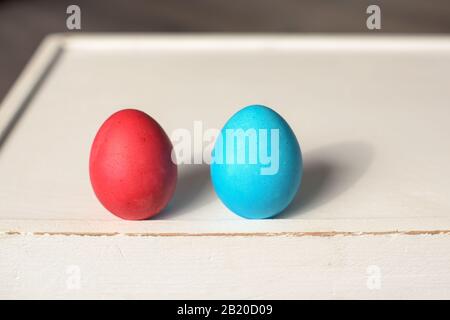 Two Easter eggs in a row- blue and red Stock Photo