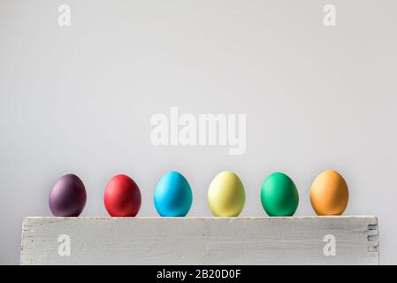 Six Easter hen eggs in different colors in a row Stock Photo