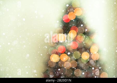 Bokeh christmas tree background with snowfall - defocused lights Stock Photo