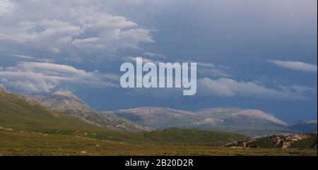 A view from the top of the Quinag mountain range, Scotland with mountain tops and sky Stock Photo