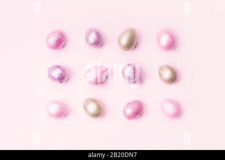 Colored painted pearl chicken and quail eggs of pink, silver, golden color Stock Photo