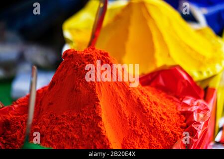 Orange color holi powder. Closeup shot of orange, yellow holi powder in a local market for Indian Holi festival with copy space. Concept for backgroun Stock Photo
