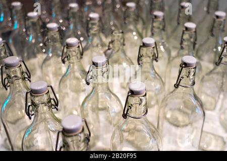 many empty glass bottles with corks, glass empty bottles with white corks background. Stock Photo