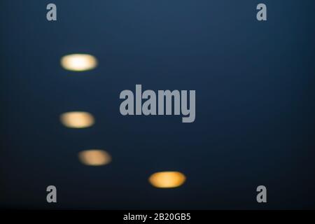 dark black background with four yellow lifgt spots Stock Photo