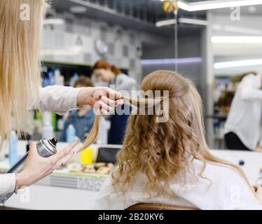 Blond Woman Using Hair Spray Stock Photo Alamy