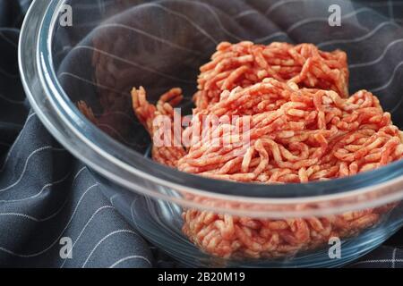 Minced beef in a glass bowl. Close up. Stock Photo