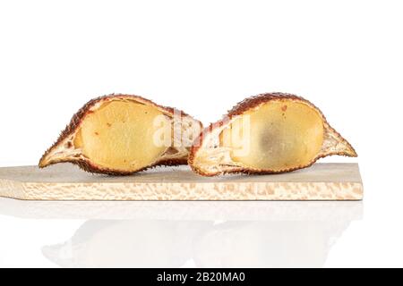 Group of two halves of exotic brown salak on wooden cutting board isolated on white background Stock Photo