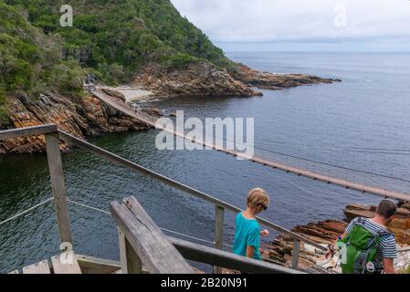 Father and son on hike through magnificent scenery at Storms River Mouth, Tsitsikamma National Park, Garden Route, near Port Elizabeth,South Africa Stock Photo