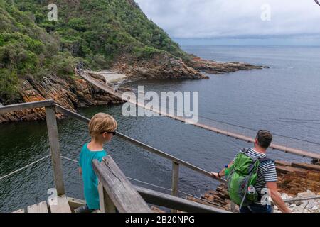 Father and son on hike through magnificent scenery at Storms River Mouth, Tsitsikamma National Park, Garden Route, near Port Elizabeth,South Africa Stock Photo