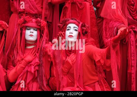 Bristol, UK - Friday 28th February 2020 - Extinction Rebellion ( XR ) Red Brigade dancers perform in the centre of Bristol as part of the Bristol Youth Strike 4 Climate march.  Photo Steven May / Alamy Live News Stock Photo