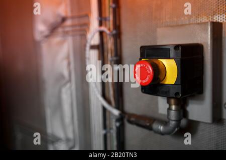 The red emergency button or stop button for Hand press. STOP Button for industrial machine, Emergency Stop. Stock Photo