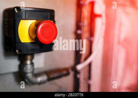 Big Red emergency button or stop button for manual pressing. STOP button for industrial equipment, emergency stop. Red light. At the factory and indus Stock Photo