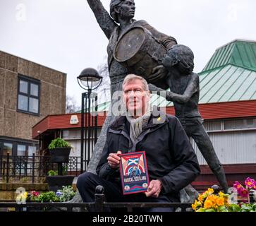 Tranent, East Lothian, Scotland, United Kingdom, 28th February 2020. Kenny MacAskill, recently elected SNP Member of Parliament for East Lothian, publishes a new book on February 27th 2020 (Biteback Publishing) called 'Radical Scotland'. One chapter describes the Tranent Massacre in 1797 in which Jackie Crookston, featured in the sculpture by David Annand behind him, was killed Stock Photo