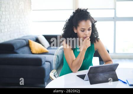 Young Black Woman Feeling Anxious And Biting Nails Stock Photo