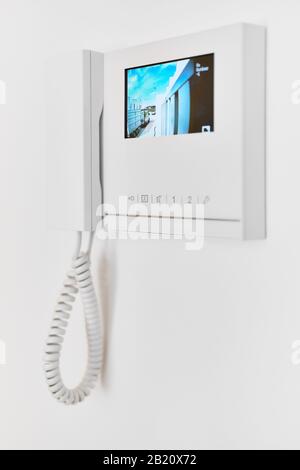 Concept of smart modern luxury wealthy home. On white wall video intercom with street view talkback or doorphone voice communications system close up Stock Photo