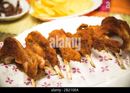 view of raw breaded lamb ribs ready to eat in a celebration Stock Photo