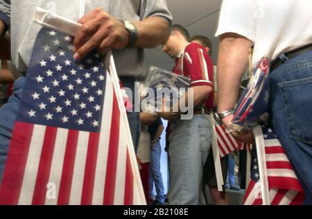 September 14, 2001, Austin, Texas: Central Texans line up outside a small business in south Austin that specializes in flag sales to snatch up a dwindling supply of American flags Friday as stores were swamped for symbols of patriotism after the terrorist attack on the World Trade Center in New York and the Pentagon.  The store's owner, Harvey Kronberg, even received calls from members of Congress to get American flags. ©Bob Daemmrich Stock Photo