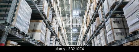 Rows of shelves with boxes in a modern warehouse Stock Photo