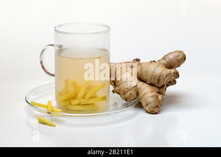 Ginger tea in glass and ginger root, Germany Stock Photo