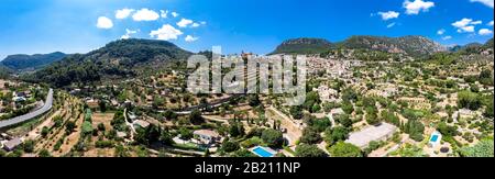 Drone shot, historical mountain village Valldemossa with Charterhouse Sa Cartoixa and parish church Sant Bartomeu, region Soller, Serra de Stock Photo