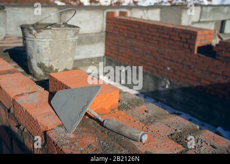 Workplace of the master in masonry. Mason trowel close-up. Industrial background Stock Photo