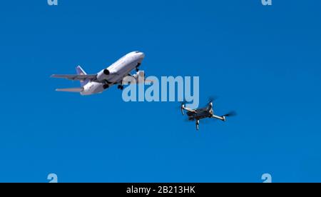 Digital Composing, photo drone DJI Mavic 2 Pro and in the background a starting Boeing 737-500 aircraft together in the airspace, Germany Stock Photo