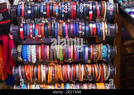 Turkey Alanya April 18, 2018: Handmade traditional colored wristbands are hanging on the special counter at the market, Turkey. Stock Photo