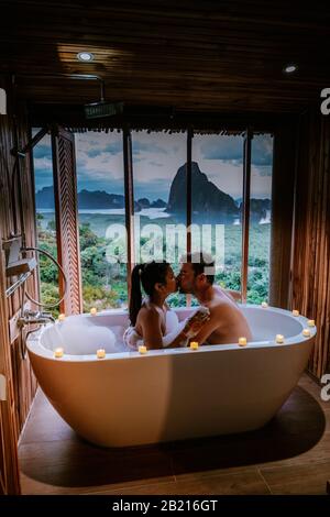 sunset in bathtub in the bathroom during vacation in Thailand watching sunset over the ocean and moutnains Phangnga Bay Thailand Stock Photo