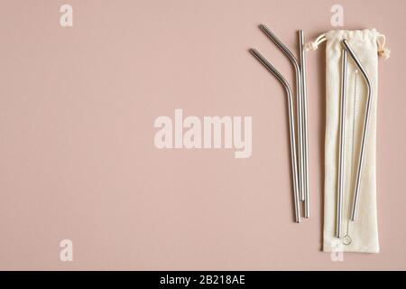 Stainless steel drinking straws with cleaning brush and case on brown background. Zero waste, plastic free concept Stock Photo