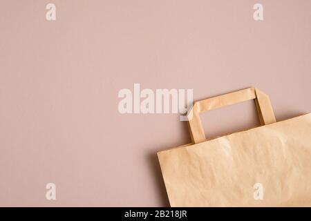 Empty kraft paper bag on brown background with copy space. Packaging template mockup Stock Photo