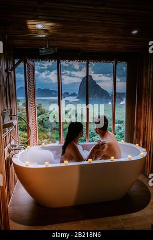 sunset in bathtub in the bathroom during vacation in Thailand watching sunset over the ocean and moutnains Phangnga Bay Thailand Stock Photo