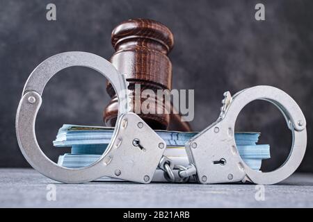 Law gavel with handcuff and banknotes Stock Photo