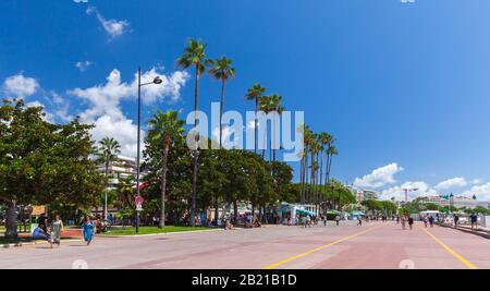 Cannes, France - August 14, 2018: People walk the Boulevard de la Croisette, street view of Cannes at sunny summer day Stock Photo