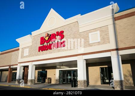 A logo sign outside of a Bob's Stores retail store ...