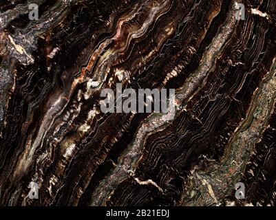 Marble spots with black, green, white and red spots, diagonal waves, brown, black, green and white marble texture. Stock Photo