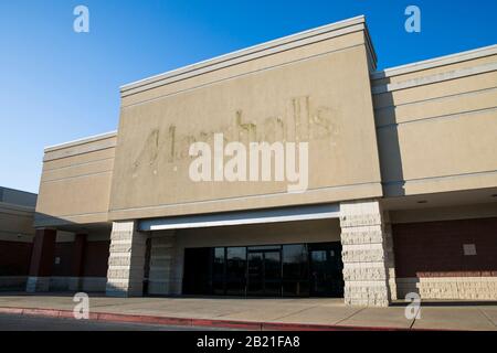 The faded outline of a Marshalls logo sign outside of a closed retail