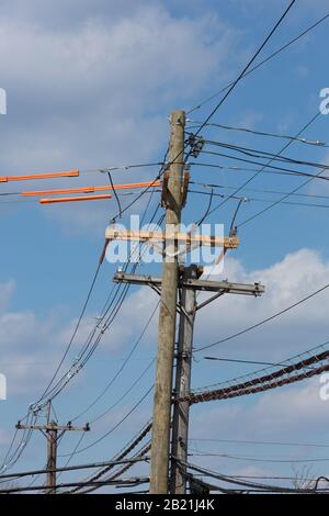 A sequence of images of a wooden electrical utility pole being replaced, taken over the course of several days. Stock Photo