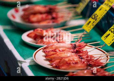 Kyoto, Japan Grilled squish fish seafood food snack on sale display in Nishiki market street Stock Photo