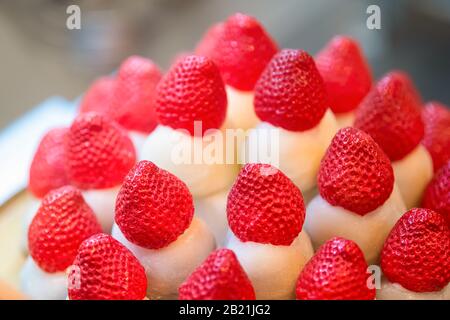 Mochi strawberries macro closeup in Japanese vendor store in Kyoto, Japan Nishiki market with vibrant red fruit and rice cake Stock Photo