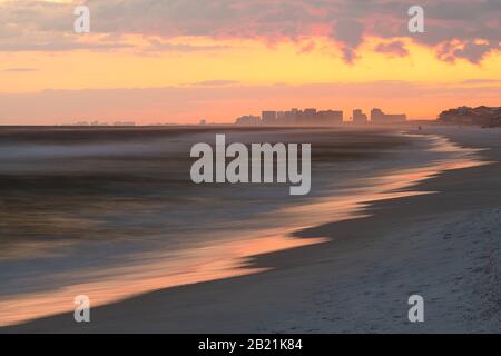 Long exposure pastel sunset in Santa Rosa Beach with Pensacola coast in Florida Panhandle at Gulf of Mexico ocean waves Stock Photo