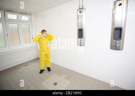 Woman in a yellow full protected suit Stock Photo