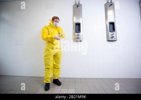 Woman in a yellow full protected suit Stock Photo