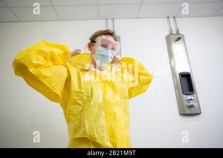 Woman in a yellow full protected suit Stock Photo