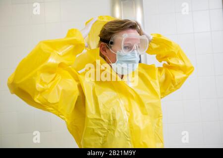 Woman in a yellow full protected suit Stock Photo