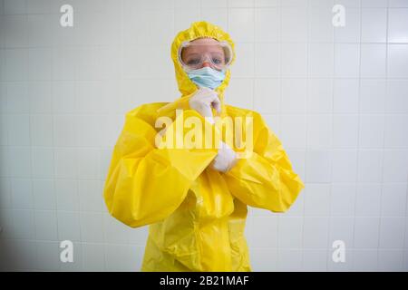 Woman in a yellow full protected suit Stock Photo