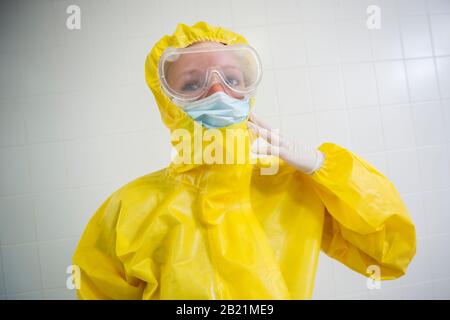 Woman in a yellow full protected suit Stock Photo