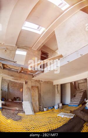 yellow underfloor heating installation with white polyethylene pipes on construction site of new two level apartment Stock Photo