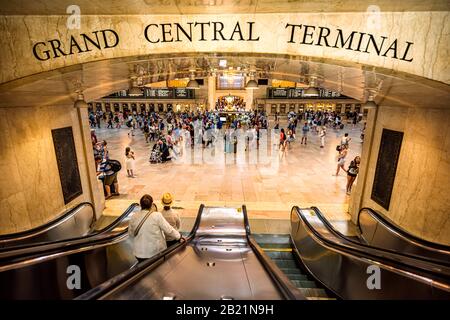 New York, USA - June 19, 2016: Sign for grand central terminal entrance in New York City with people riding entering by escalator near busy hall Stock Photo