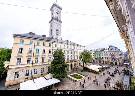 Lviv, Ukraine - July 31, 2018: Exterior above view of historic Ukrainian city in old town market square Ratusha City Hall wide angle building from win Stock Photo
