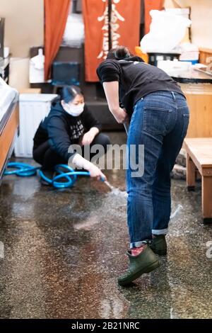 Kyoto, Japan - April 17, 2019: People in Nishiki market street shops cleaning sweeping store restaurant izakaya Stock Photo